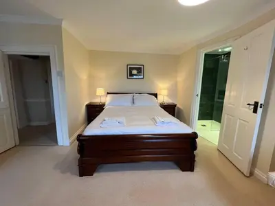 a bedroom with a bed and a door to a bathroom at House - Sleeps 10 Pet friendly & Parking in Wigton