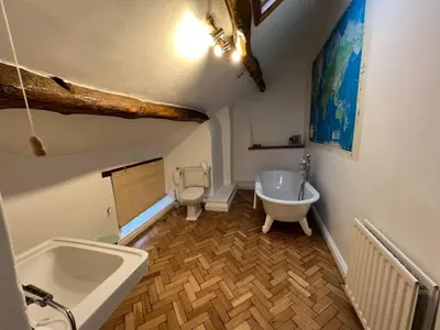 a bathroom with a bath tub and a toilet at House - Sleeps 10 Pet friendly & Parking in Wigton