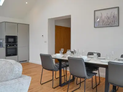a dining room with a table and chairs at Old Byre Cottage - Uk43377 in Kirklinton