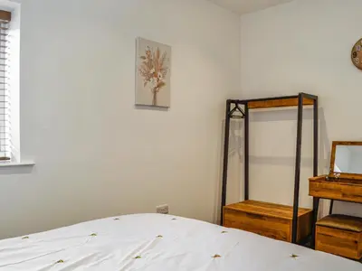 a bedroom with a bed and a mirror at Fell View Cottage - Uk43378 in Kirklinton