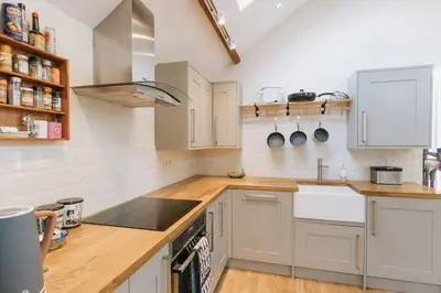 a kitchen with white cabinets and a counter top at ELM HOUSE BARN - Converted One Bed Barn at the gateway to the Lake District National Park in High Hesket
