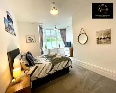 a bedroom with a bed and a window at Three Bedroom in Seascale