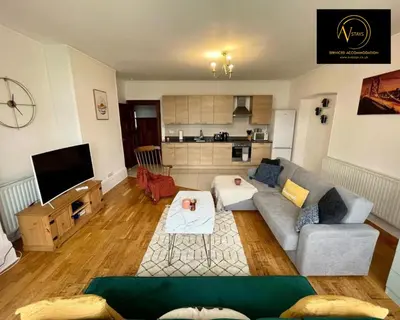 a living room with a couch and a tv at Three Bedroom in Seascale