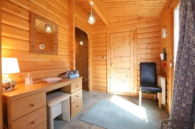 a room with a desk and a chair in a cabin at Birchlea in Kippford