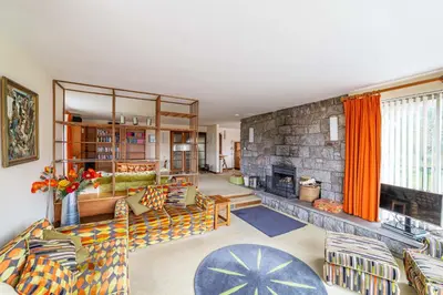 a living room with a stone wall at Bells View in Kippford