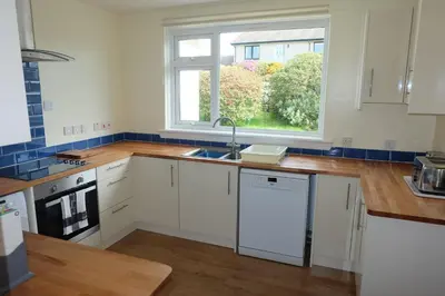 a kitchen with a sink and a window at Tir Nan Og in Rockcliffe