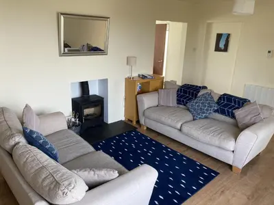 a living room with two couches and a fireplace at Tir Nan Og in Rockcliffe