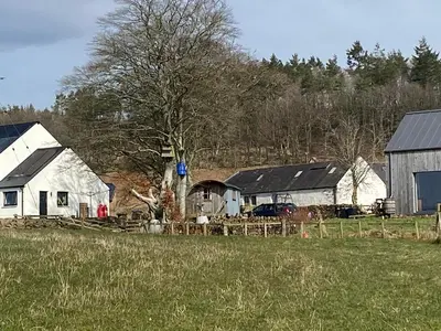 a group of barns and a field with a tree at Granny’s Hut in Thornhill