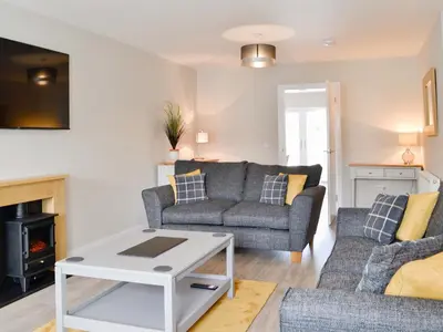 a living room with a couch and a table at Crofthouse - Uk43405 in Wigtown