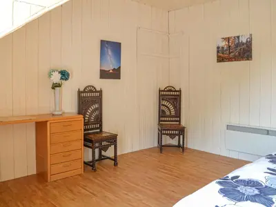 a bedroom with two chairs and a desk and a bed at Mossdale in Rockcliffe