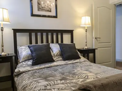 a bedroom with a bed with two lamps on both sides at Quayside7 in Whitehaven