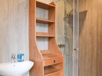 a bathroom with a sink and a shower at The Coach House in Blencogo
