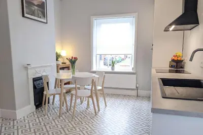 a kitchen and dining room with a table and chairs at Townhouse Apartment Carlisle in Carlisle
