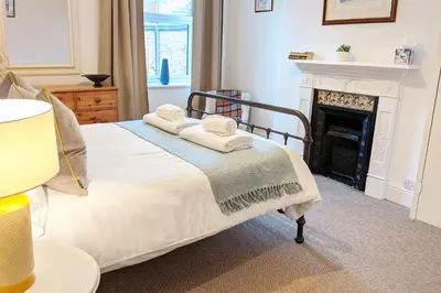 a bedroom with a bed with towels on it at Townhouse Apartment Carlisle in Carlisle