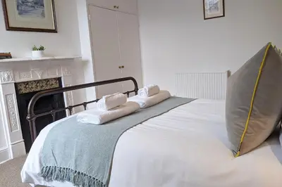 a bedroom with a bed with towels on it at Townhouse Apartment Carlisle in Carlisle