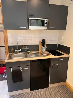a kitchen with a sink and a microwave at Wrens nest in Newton Stewart
