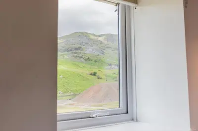 a window with a view of a mountain at Fellside Cottage Coppermines Valley in Coniston