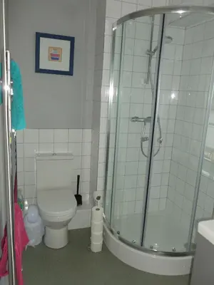 a bathroom with a toilet and a glass shower at The Coach House, Hesket Newmarket in Hesket Newmarket