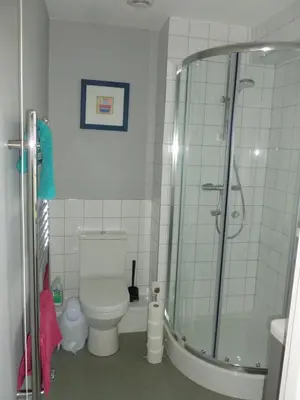 a bathroom with a toilet and a glass shower at The Coach House, Hesket Newmarket in Hesket Newmarket