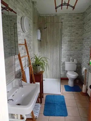 a bathroom with a tub and a sink and a toilet at BARHOLM CROFT Holiday Cottage in Creetown
