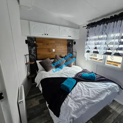 a bedroom with a bed in a small room at Kates Home Lagganhouse Woodland Way 19 in Ballantrae