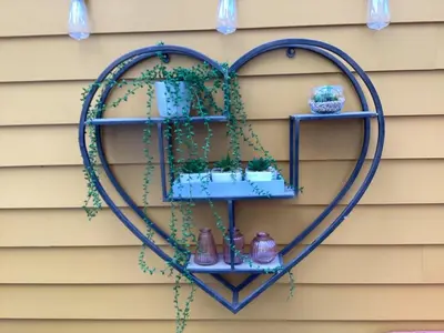 a heart shaped shelf on the side of a house at Porch Cottage, a luxurious characterful cottage within walking distance of Keswick town centre in Keswick