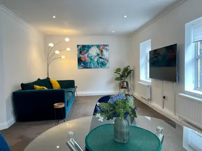 a living room with a couch and a table at The Apartment, Bridge House in Laxey