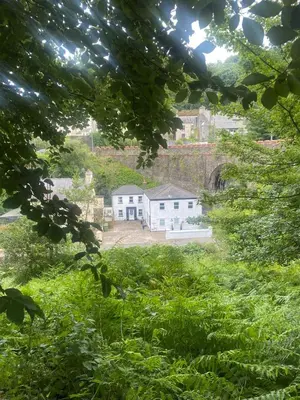 a view of a house in a field of grass at The Apartment, Bridge House in Laxey