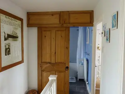 a hallway with a wooden door in a room at Gulls Hatch in Maryport