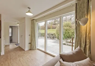 a living room with a large sliding glass door at Skerrow in New Galloway