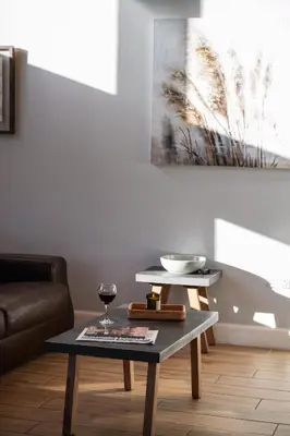 a living room with a table and a glass of wine at Kestrel Lodge 3 with Hot Tub in Newton Stewart
