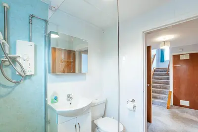 a bathroom with a sink and a toilet at Foxbrae Cottage in Rockcliffe