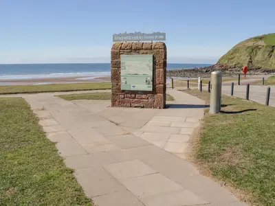 a sign on a sidewalk near the beach at Seaspray in St Bees