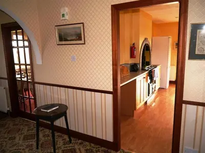 a kitchen with a counter and a table in a room at Collin Hill House in Castle Douglas