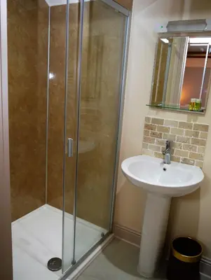 a bathroom with a shower and a sink at Rusko Stables in Gatehouse of Fleet