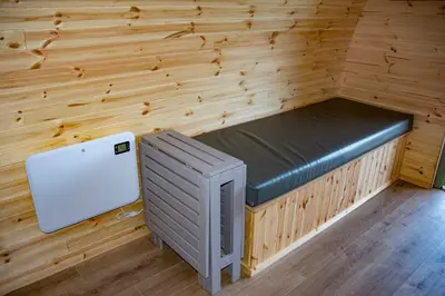 a sauna with a bench and a refrigerator in a room at Glamping Pod 2 Magical Craigengillan Estate in Dalmellington