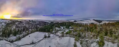 an aerial view of a snow covered mountain with a house at Glamping Pod 2 Magical Craigengillan Estate in Dalmellington