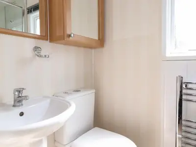 a bathroom with a white toilet and a sink at Whiteside in Cockermouth