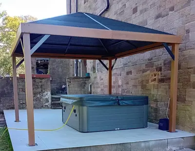 a gazebo with a blue roof on a patio at Eta's Manor @ Brooklands in Maryport