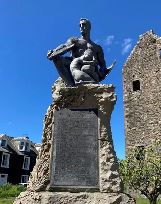 a statue of a woman holding a child on a monument at Serendipity in Kirkcudbright